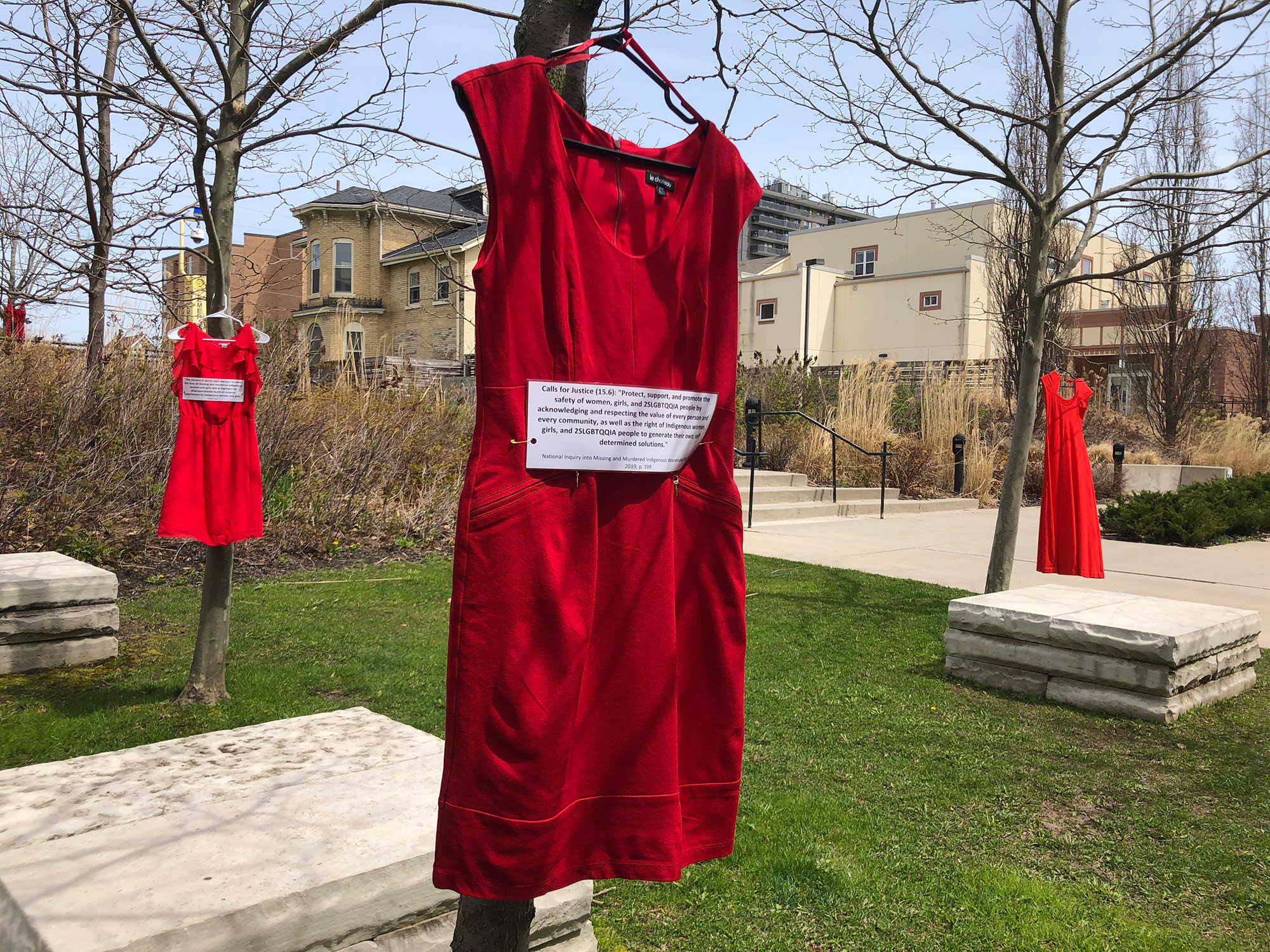 Red dresses hanging from trees
