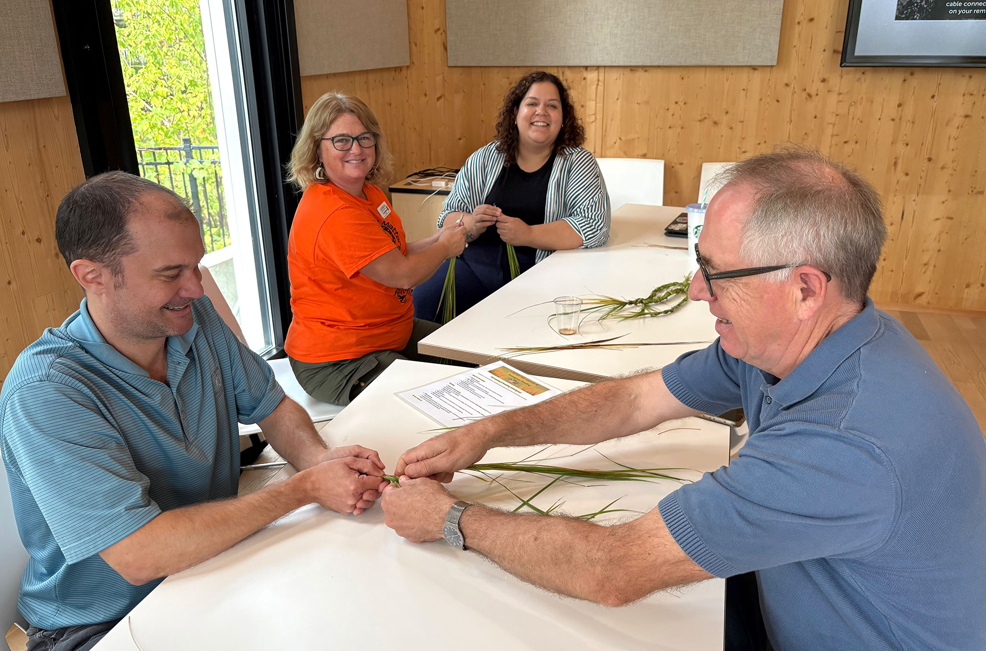 faculty and staff learning to braid sweetgrass