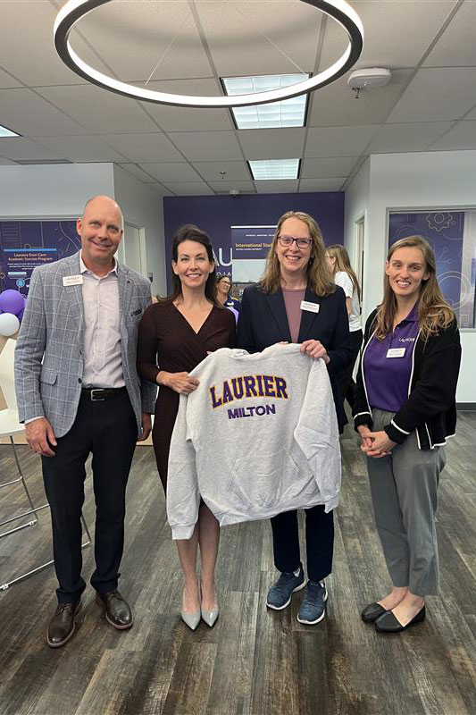 Milton leaders hold up Laurier sweater