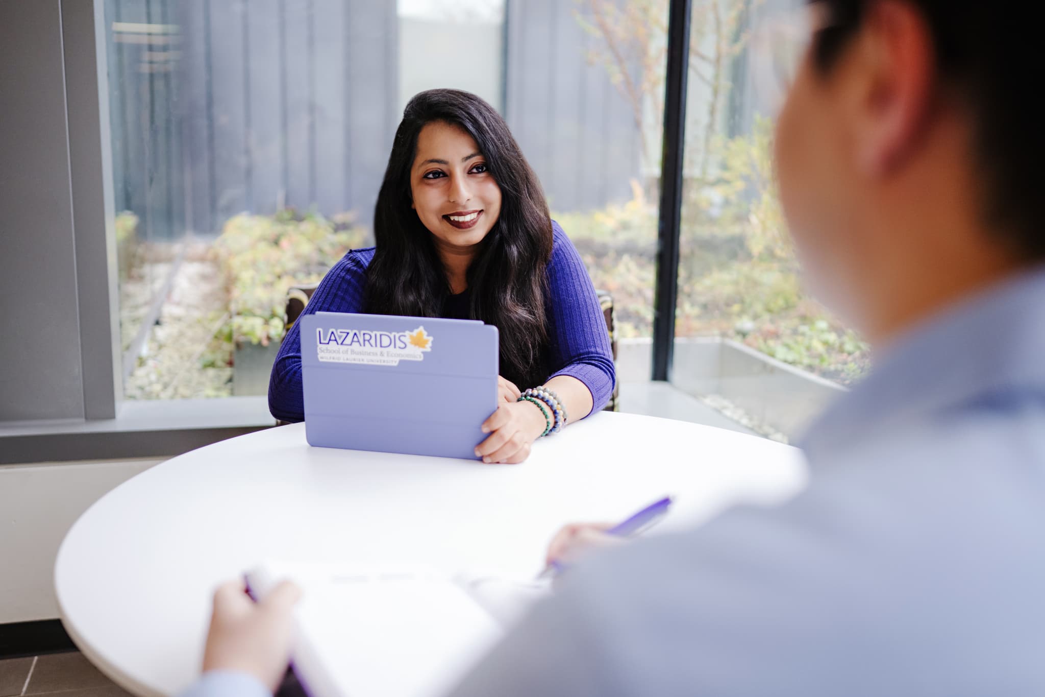Lazaridis Hall atrium full of students studying at tables