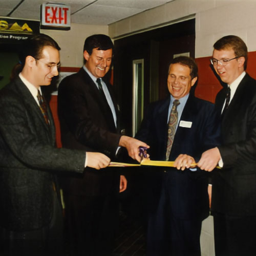 Group cutting ribbon at Prism Lab opening (1990)