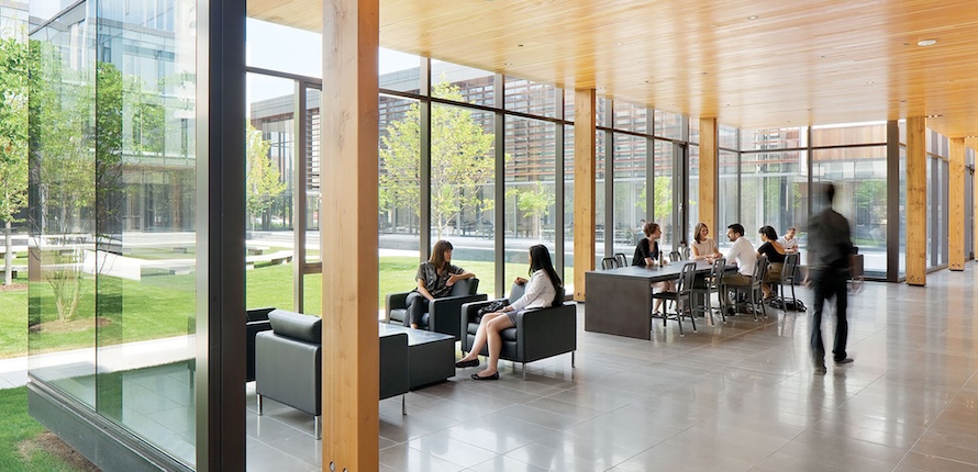 People sitting at tables and chairs in the Balsillie School