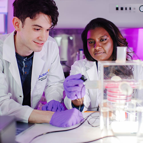 Murugan works in lab with student