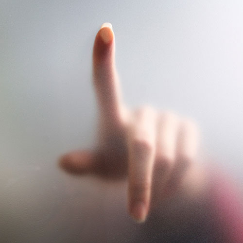 hand touching frosted glass