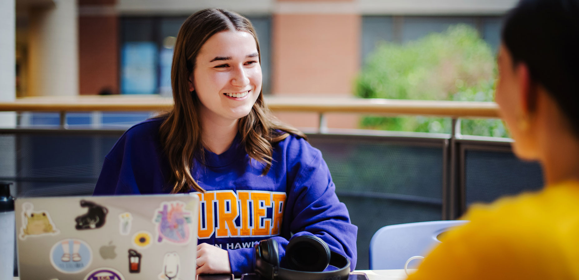 student works on campus on a laptop