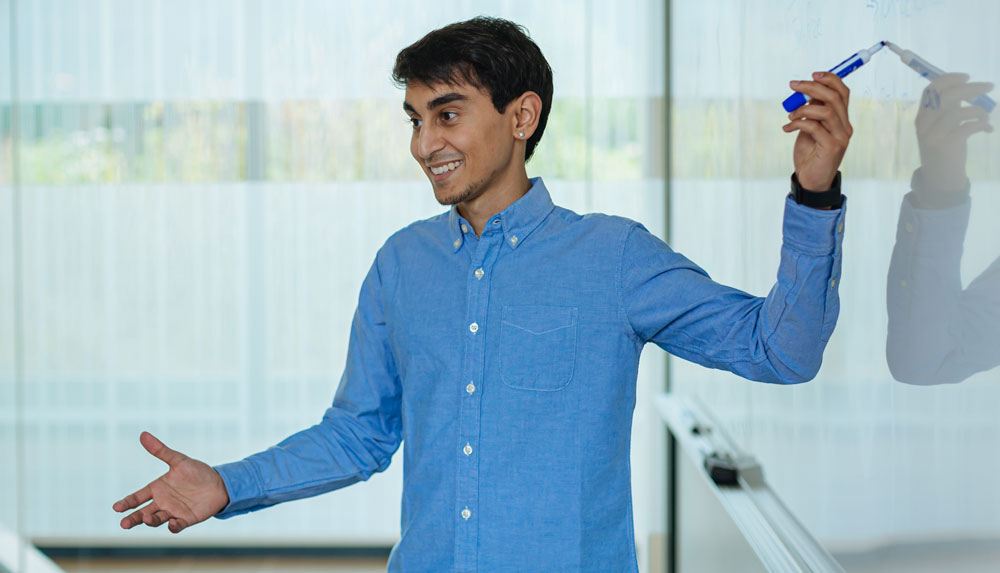 student at chalkboard