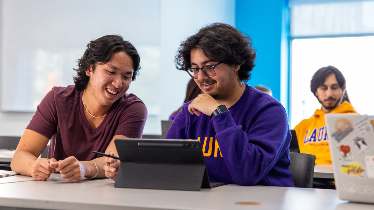 male students in brantford classroom looking at laptop