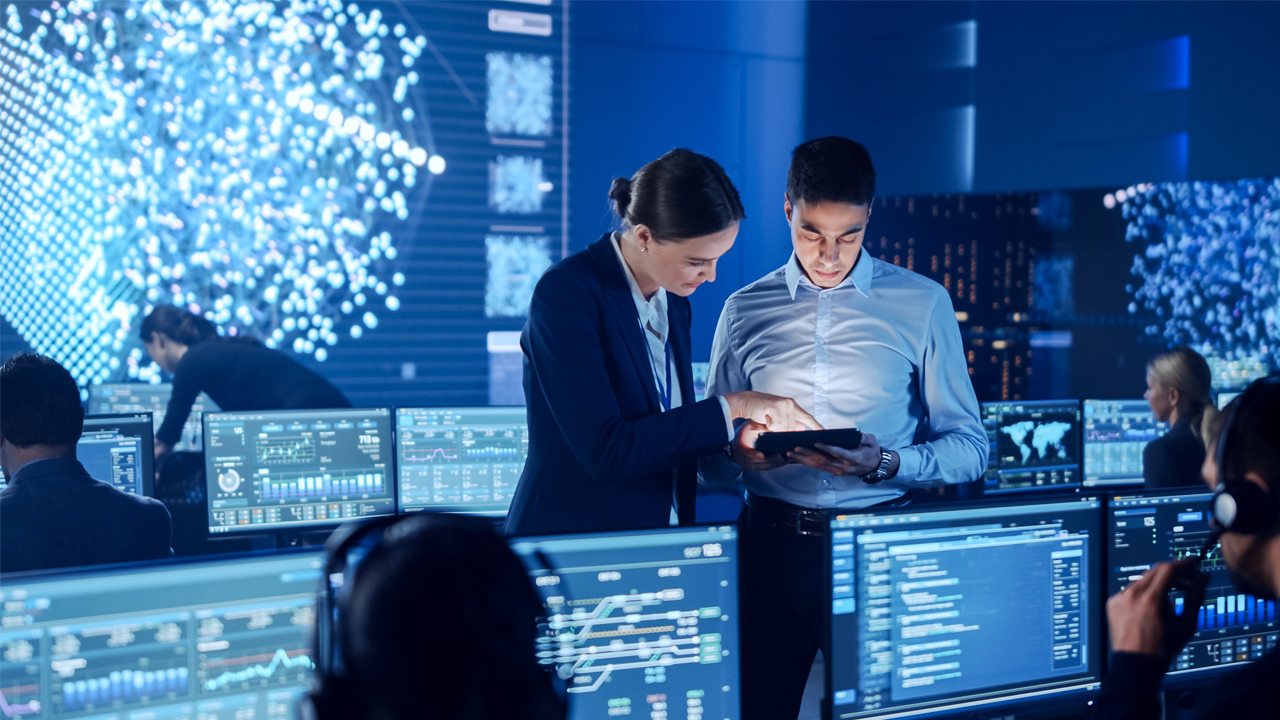 tech workers in a blue room monitoring