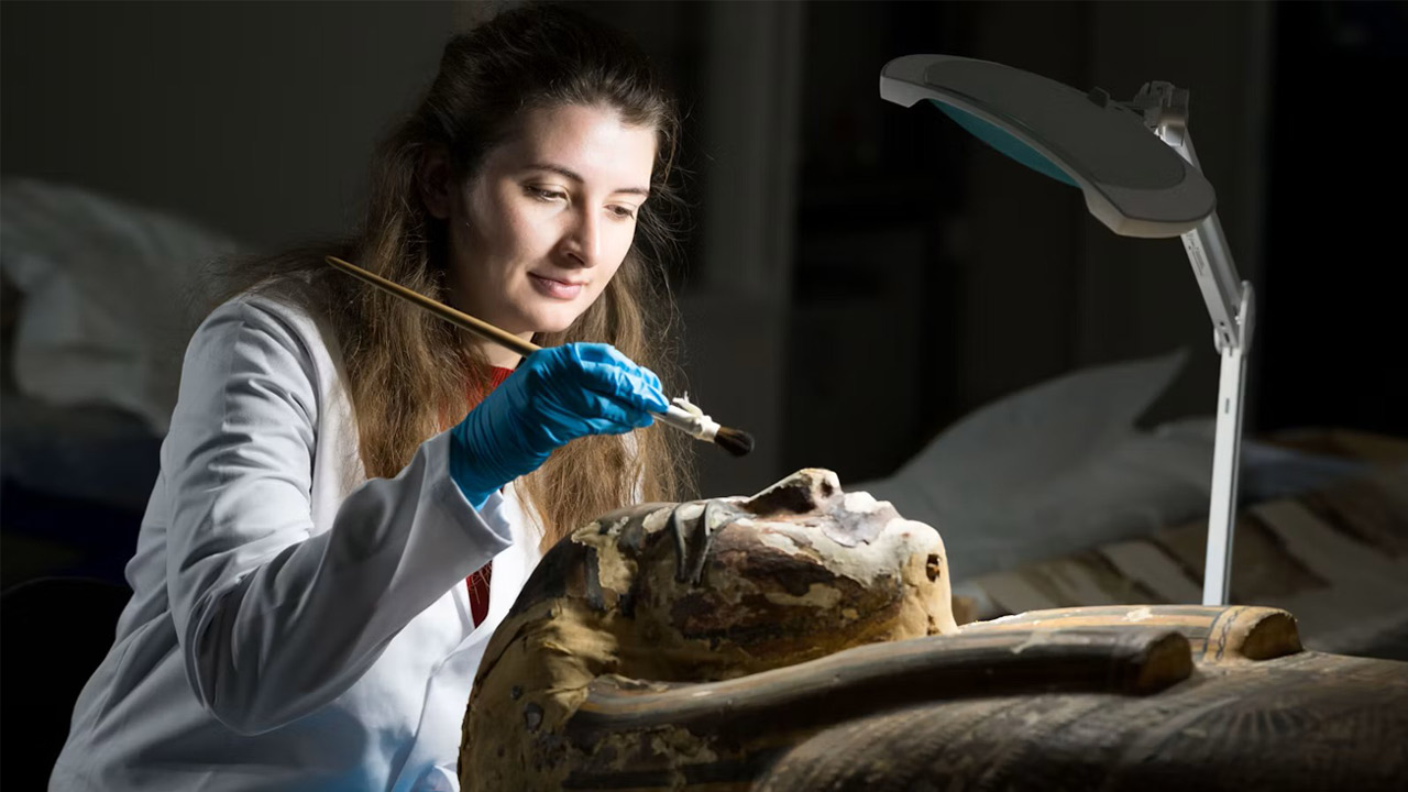 student cleaning sarcophagus